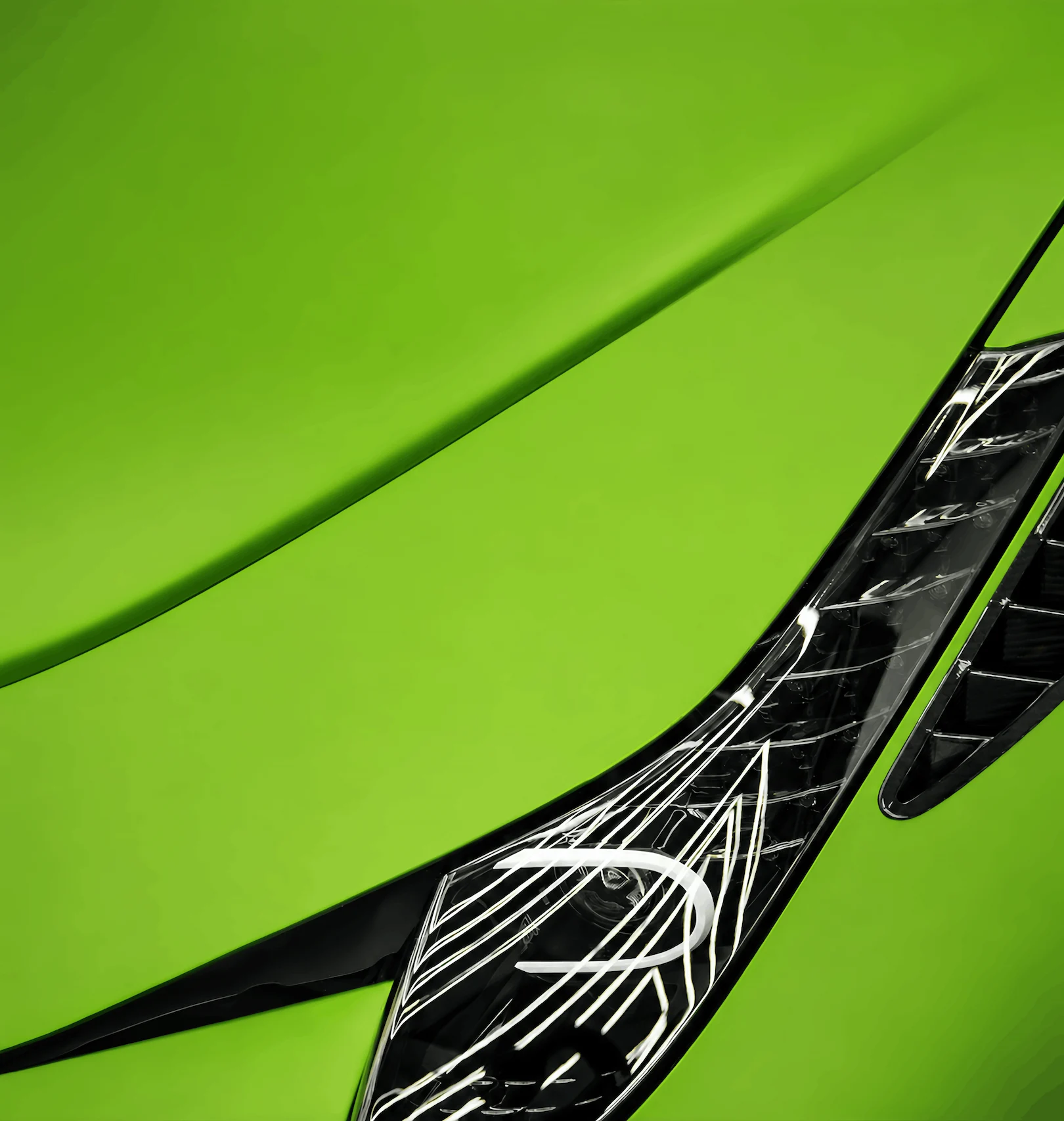 Close-up of a sports car featuring a vibrant green automotive paint finish by Numix